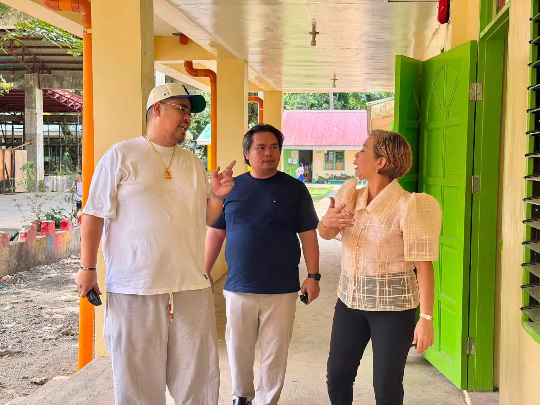 CTNP CSO Silver Cepeda, John Albert Quial, and Councilor Ian Galo walking through Sabang Integrated School