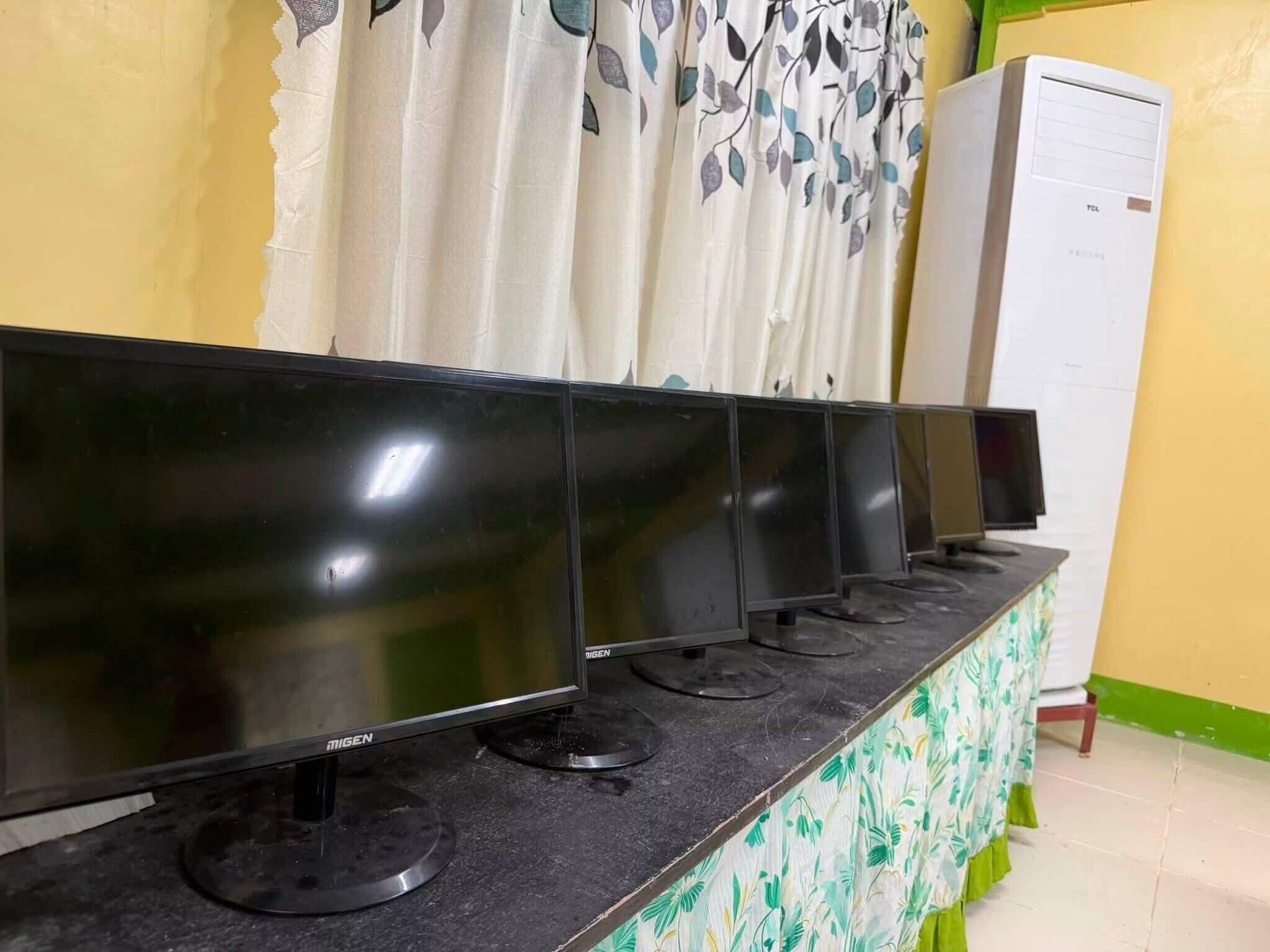 Computer monitors set up in a classroom at Sabang Integrated School